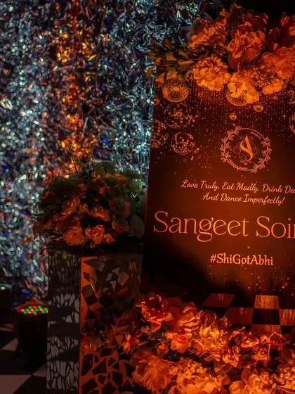 A personalized welcome sign for the 'Sangeet Soiree'. The design, featuring the couple's hashtag, sets a chic and celebratory tone for the evening.