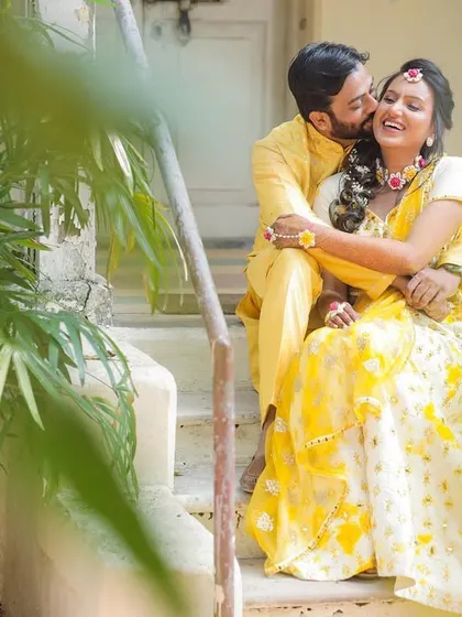 A sweet and playful moment on the steps. The groom stealing a kiss makes for a perfect candid shot.