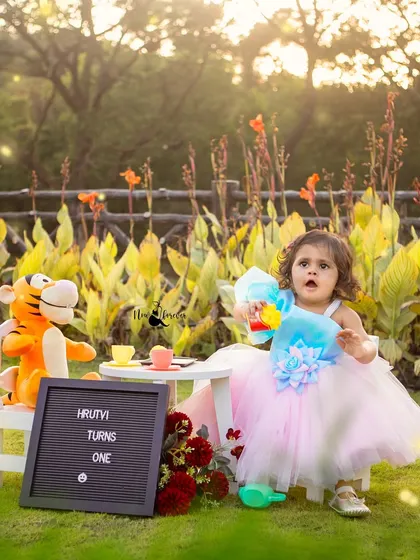 A whimsical first birthday tea party in the garden. The golden hour light makes this celebration feel extra magical.