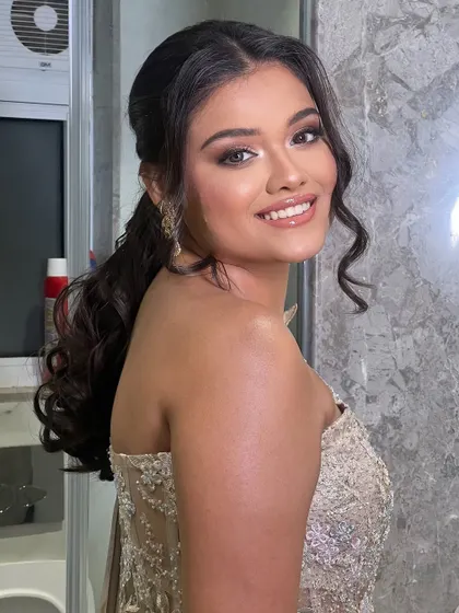 A chic and modern half-up ponytail. This style is perfect for a pre-wedding reception or cocktail party, keeping the hair stylishly off the face.