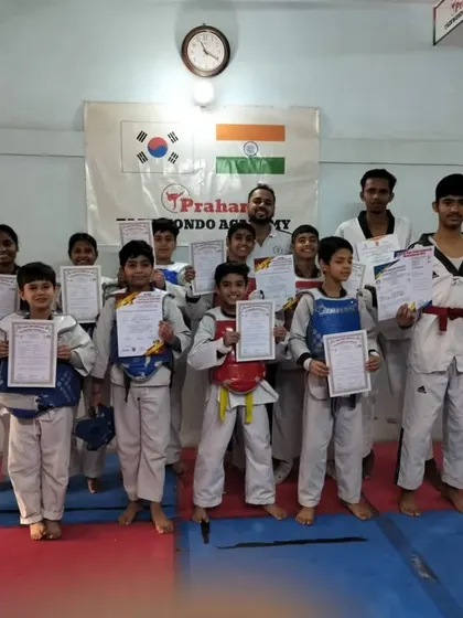 A large group of our students with their certificates after a belt test. This shows the scale of our growing Taekwondo family.