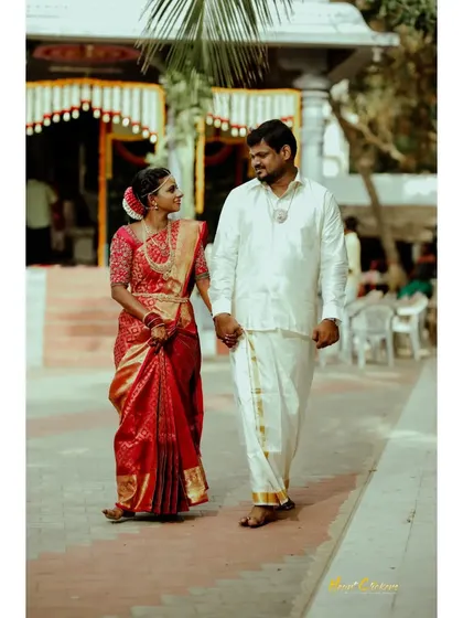 A couple walking hand-in-hand in their traditional wedding attire, a timeless portrait of their new beginning.