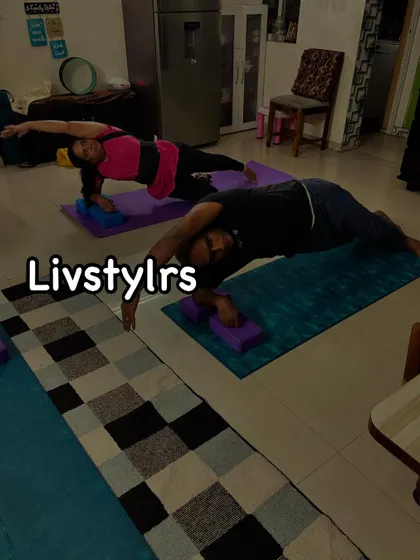 Two clients perform a modified side plank, using blocks for support. This pose is excellent for strengthening the obliques and improving overall core stability.