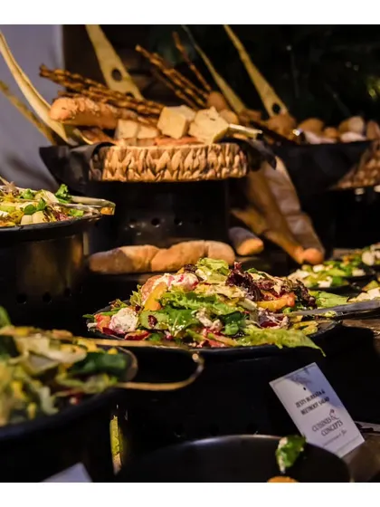 A fresh and healthy salad bar section of our buffet, featuring a variety of mixed greens, vegetables, and bread options.