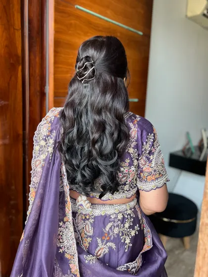 The hairstyle is just as important as the outfit. We opted for soft waves and a chic, modern hair accessory to complete the mother of the groom's elegant look.