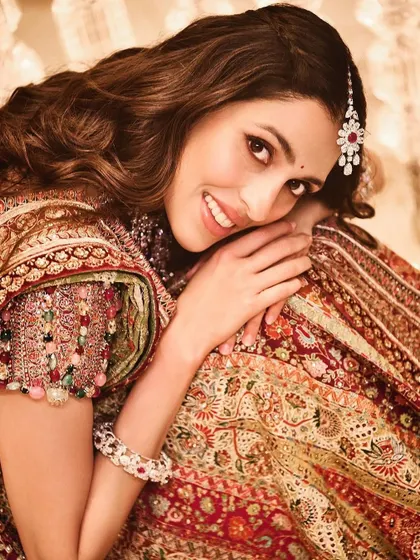 A stunning close-up from a Garba night celebration. This Tarun Tahiliani lehenga is rich in color and tradition, complemented by a radiant smile.
