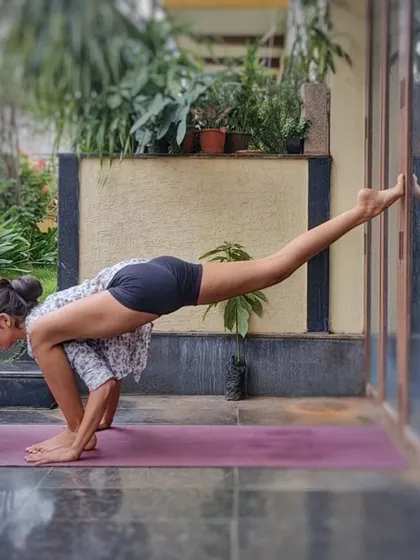 A variation of Flying Splits using a wall for support. This pose is a powerful arm balance that also deeply opens the hips, and the wall helps in finding the correct form.
