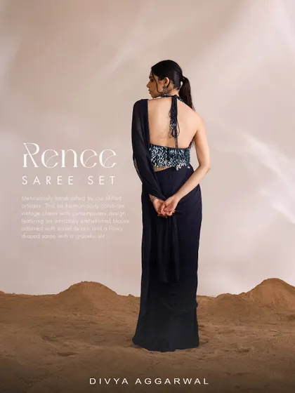 The Renee Saree Set in a deep navy blue. This backless, halter-neck design features a pre-draped saree with a slit, combining vintage charm with a contemporary, daring silhouette.