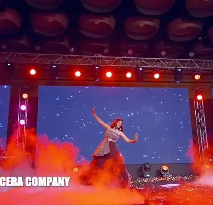 The stage is set for an emotional and powerful performance. The red and purple lighting adds to the drama of this sibling's solo dance.