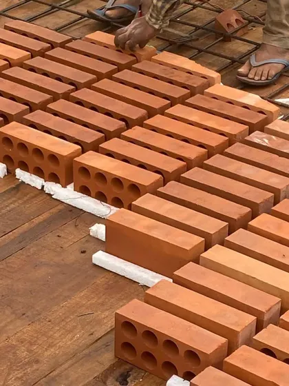 A close-up of the perforated bricks used in the filler slab construction. These locally sourced materials are chosen for their aesthetic qualities and their contribution to a more sustainable building process.