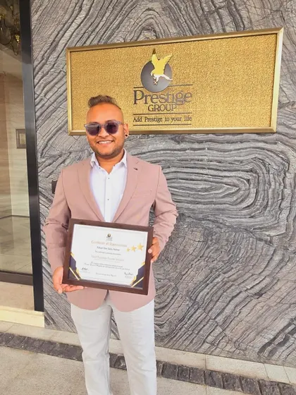 Posing with a certificate of appreciation outside the Prestige Group headquarters. Building strong relationships with top developers helps me secure the best properties for you.