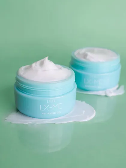 This shot for DHC Beauty showcases the product's texture with a satisfying smear on a reflective surface, giving a sense of its smooth and hydrating properties.