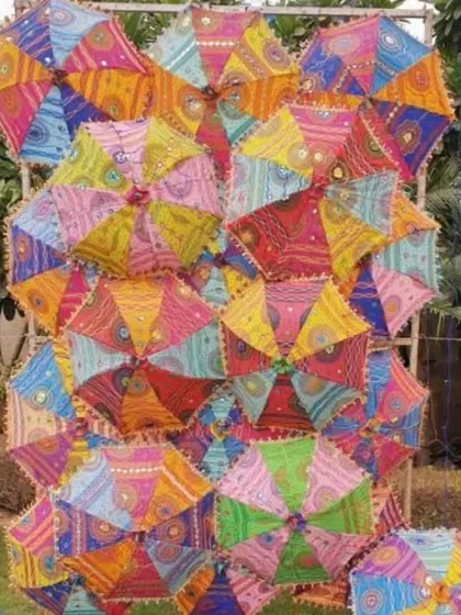 A wall of colorful Rajasthani umbrellas used as a standalone decorative element for a vibrant photo opportunity.
