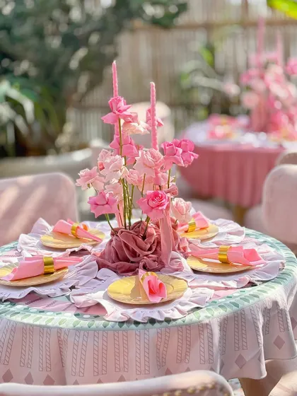 A different table setup from the same event, using a patterned tablecloth but maintaining the blush pink theme.