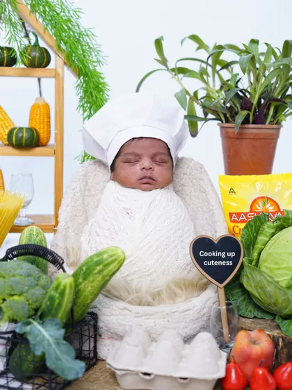 The full "tiny chef" setup, showing how all the props come together to create a realistic and adorable kitchen scene for the newborn.