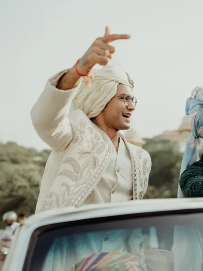 The groom arriving in style in a vintage car for his baraat.