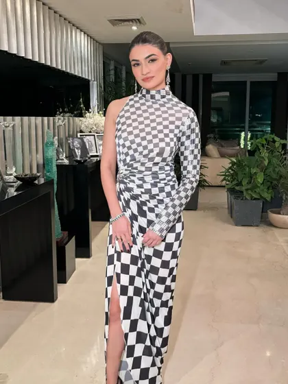 A full-length shot of this modern and edgy look. The makeup is minimal to let the architectural dress be the star.