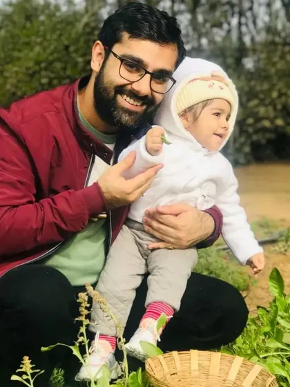 A father and his baby enjoying the greenery. This image is a sweet reminder that farm visits are a wonderful experience for all members of the family.