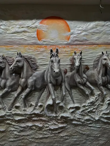 A detailed shot focusing on the central horses in the dark mural, highlighting the contrast between their powerful forms and the fiery sun.
