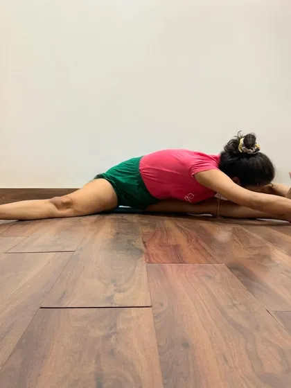 Upavistha Konasana (Wide-Angled Seated Forward Bend) is a deep forward bend that stretches the hamstrings and inner thighs. This pose calms the brain and releases tension from the groin and spine.