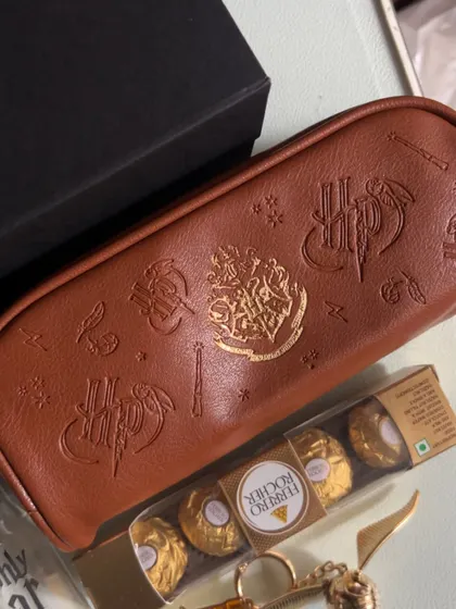 A Harry Potter themed pouch, perfect for storing stationery or other small treasures, paired with Ferrero Rocher chocolates.