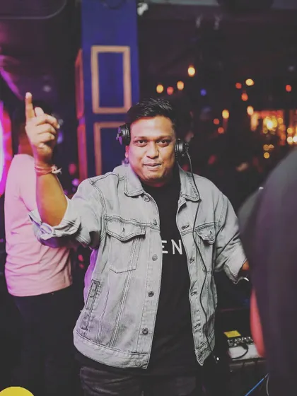 A moment of confidence behind the decks. This is my domain, and I'm ready to take the crowd on a musical journey.