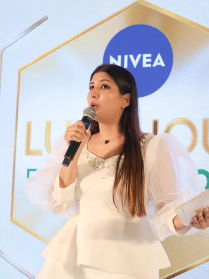 A candid, close-up shot during the Nivea launch event, showing my focus and command as a product launch presenter.