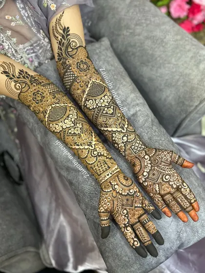 A beautiful shot of Saniya's full bridal henna on both arms, showcasing the symmetry and intricate details.