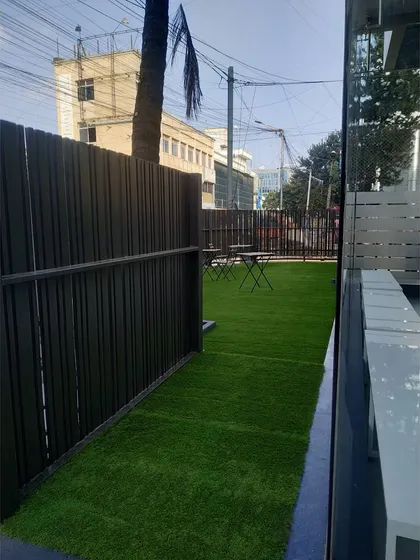 The outdoor lounge area, featuring artificial turf for a low-maintenance green space. This area provides a place for members to relax before or after their class.