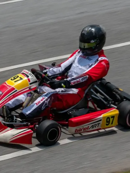 A high-angle shot of kart 97 on the track, showcasing the clean racing lines our drivers are coached to execute for optimal lap times.