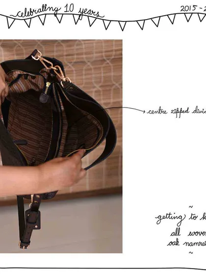 A look inside the All Woven Oak Namrata, showing the center zipped divider that helps keep this large hobo bag organized.