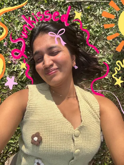 A sunkissed selfie in the grass, with a sun, stars, and bows doodled in for an extra cute vibe.