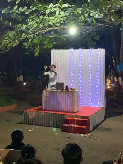 A solo moment on the beautifully lit stage during a night event. I come fully equipped with my own props and setup to deliver a professional stage show, no matter the location.