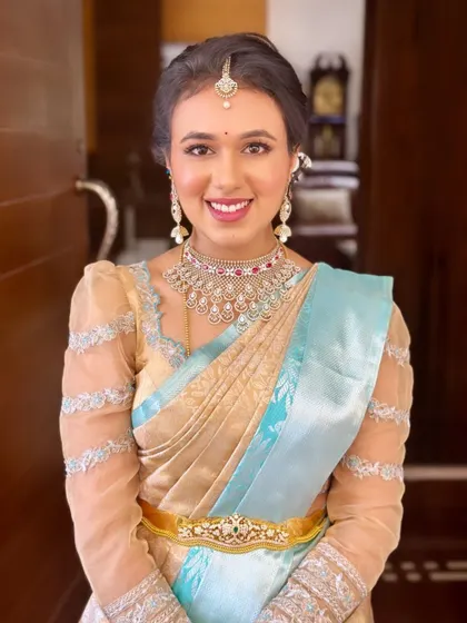 A full-face portrait of Dr. Niharika, showcasing the clean, radiant makeup that enhances her natural beauty.