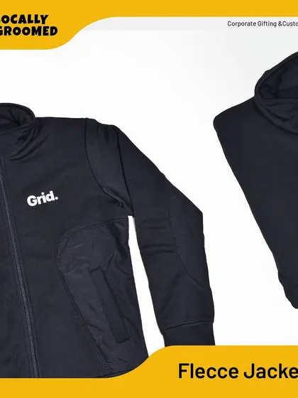 A sleek, black fleece jacket customized for 'Grid.' This is a great example of our outerwear options, perfect for corporate branding or keeping your team warm.