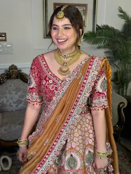 The joy on her face says it all. Her makeup is radiant and glowing, a perfect match for her vibrant personality and stunning outfit.