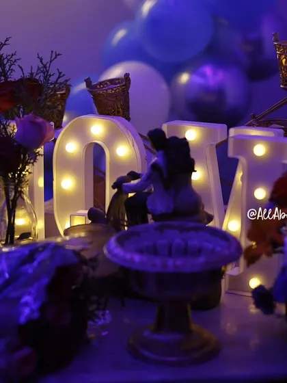 The little details matter. This shot highlights the romantic figurines and 'LOVE' marquee letters that add a personal touch to the decor.