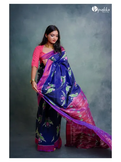 A product shot of a beautiful blue and pink saree. The way the fabric is displayed shows off its color, pattern, and flow.