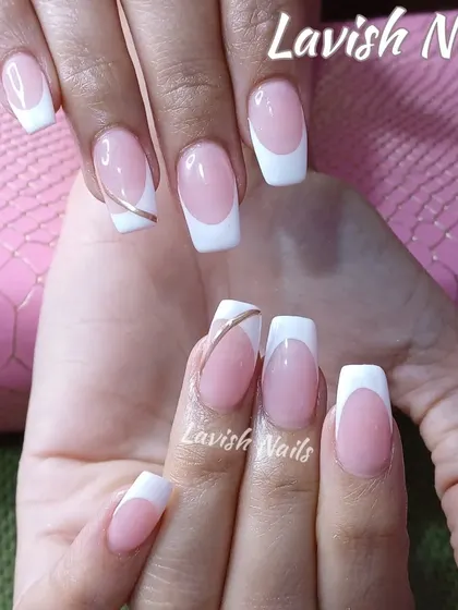 A modern French manicure on square nails with a thin gold line accentuating one of the nails for a subtle, chic detail.