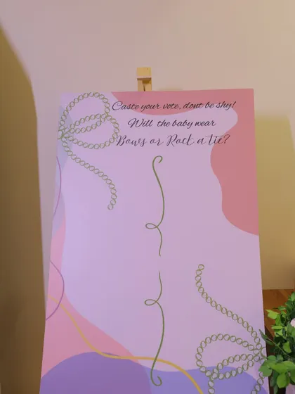 A "Bows or Ties" gender reveal voting board. Guests can cast their vote on this beautifully designed sign, adding an element of anticipation and fun to the baby shower.