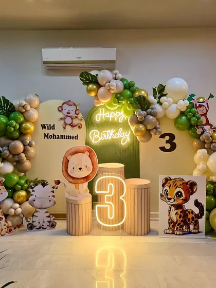A full view of the 'Wild Mohammed' jungle theme setup, showcasing the complete arrangement of balloons, backdrops, and character cutouts.