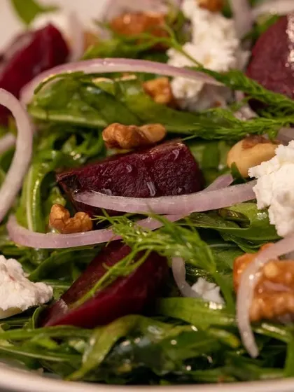 A close-up on the textures of our beetroot salad. It's a refreshing dish that pairs wonderfully with one of our whole-wheat pizzas.
