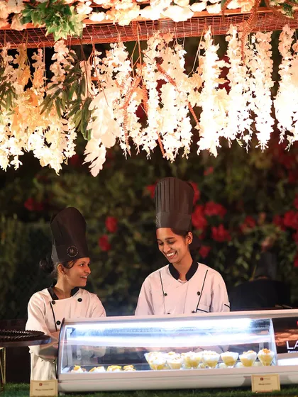 Our female chefs share a smile at their dessert station. This candid moment captures the positive and collaborative atmosphere within our team.