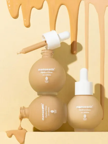 A playful tower of serum bottles with cascading drips of product. This shot is designed to be eye-catching and a little messy, showing off the serum's texture and color in a fun, unconventional way.