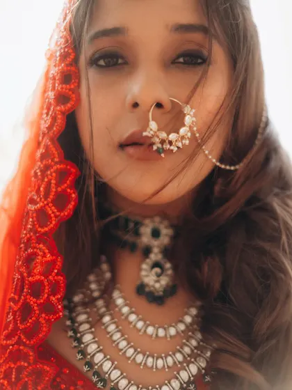 A stunning close-up of the bride, focusing on her expressive eyes and traditional nose ring. These are the portraits that feel both timeless and modern.