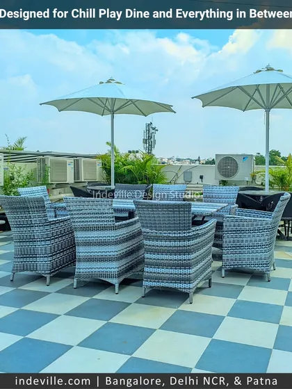 This rooftop is designed for everything from chilling to playing. I installed stylish rattan furniture under large umbrellas for dining and lounging, alongside a dedicated cricket net, making it a truly multi-functional lifestyle zone.