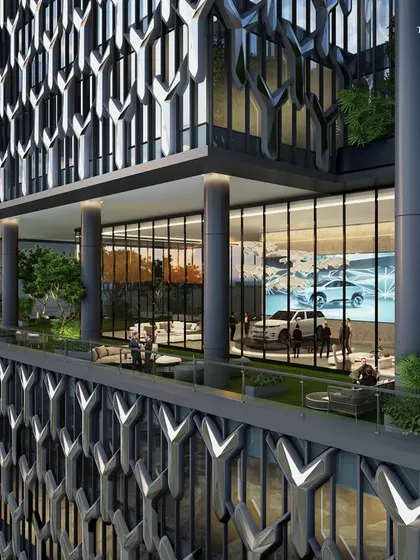 A close-up of the Worli tower's facade, revealing a car showroom integrated into one of the stepped terraces. This detail demonstrates our ability to blend bespoke commercial needs within a complex, innovative design.