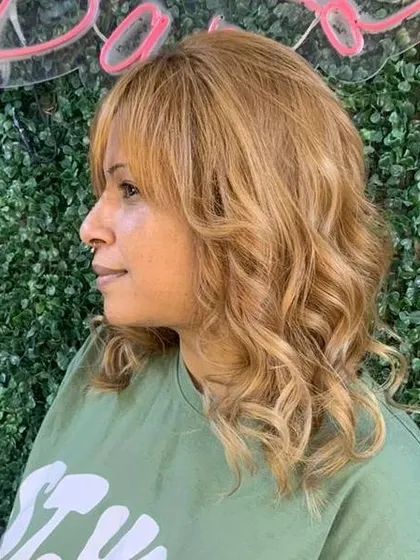 A warm, golden blonde global color. Achieving this level of lightness and even tone requires skill and the right products to keep the hair healthy.