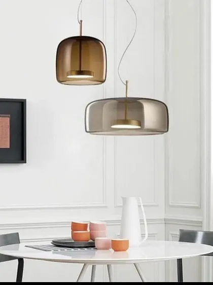 A pair of smoked glass pendants with a soft, modern shape. These are perfect for hanging over a dining table for an intimate feel.