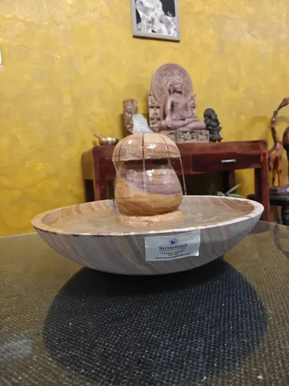 The light catches the beautiful patterns of the Rainbow Sandstone in this tabletop fountain.